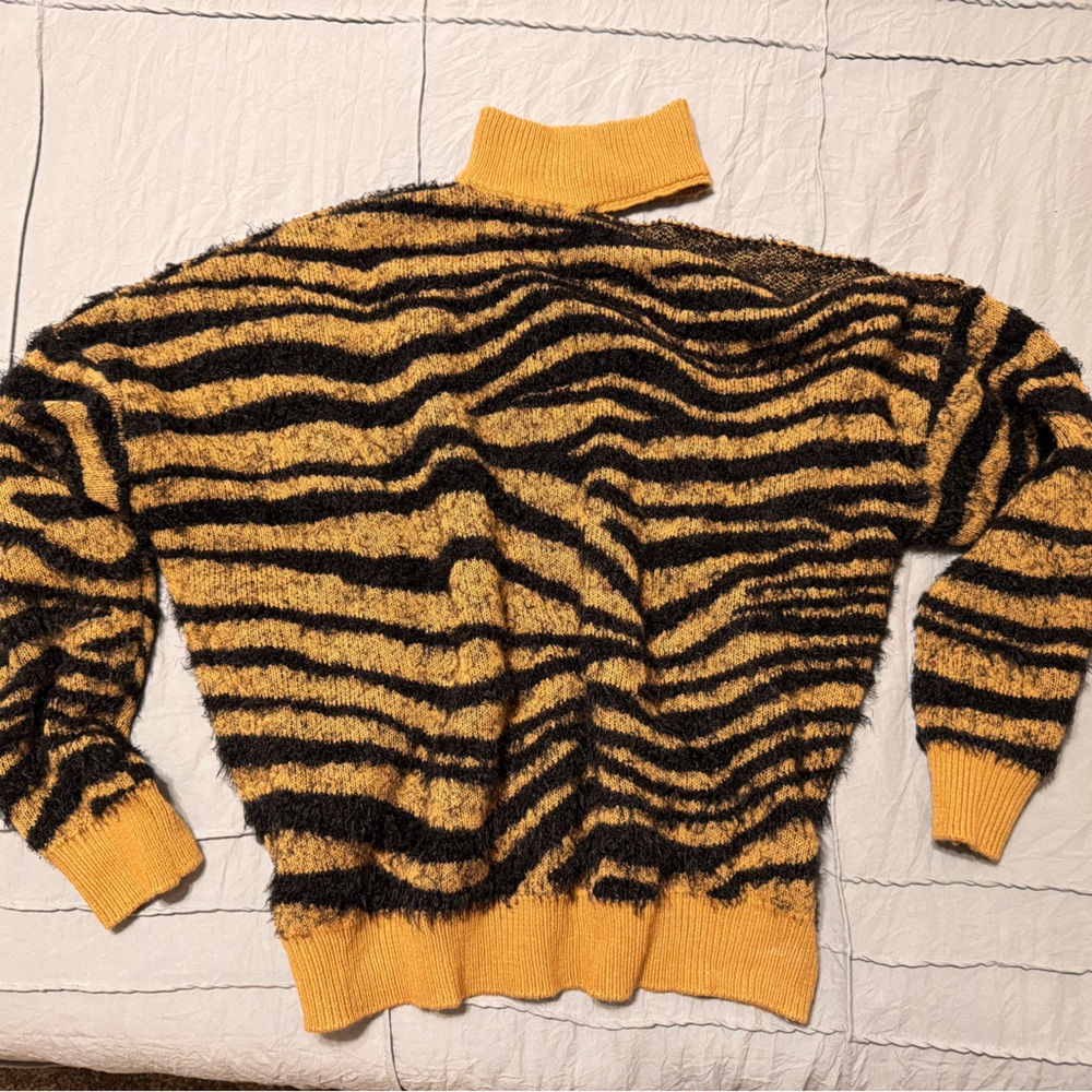 Black and gold animal print sweater with one open shoulder